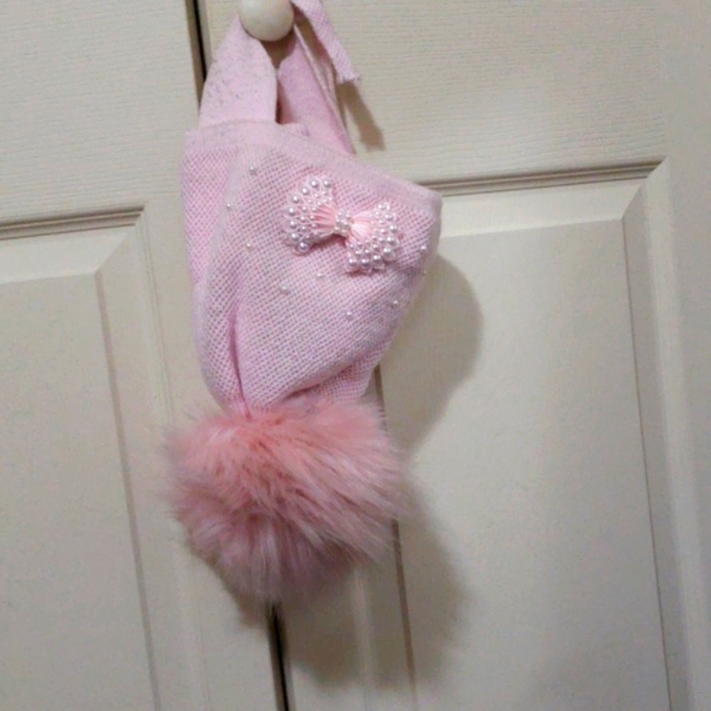 Pink Winter hat with oversized pom- pom.